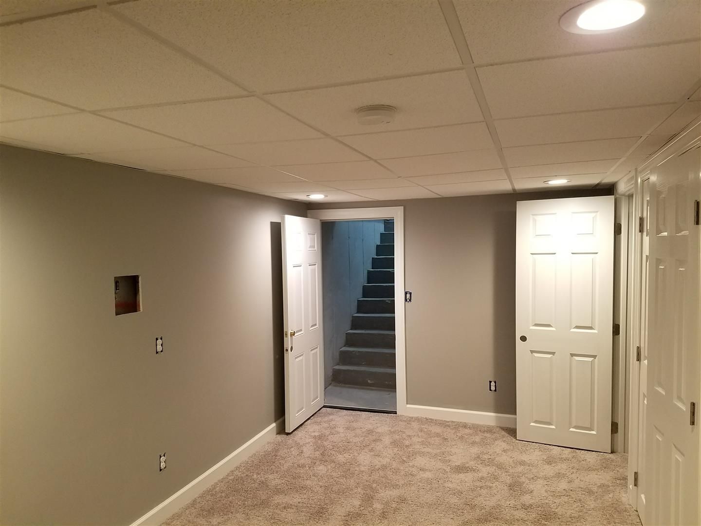 A basement with a staircase leading up to the second floor.