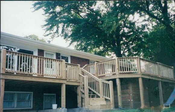 A house with a large wooden deck and stairs