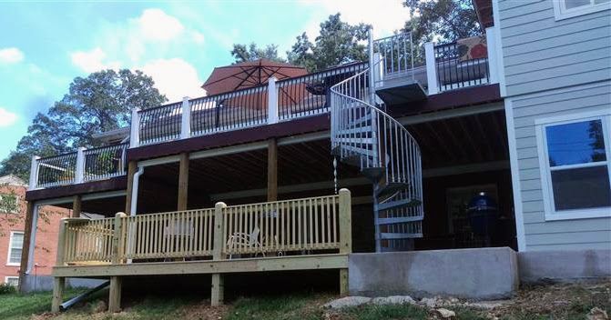 A house with a large deck and stairs leading up to it