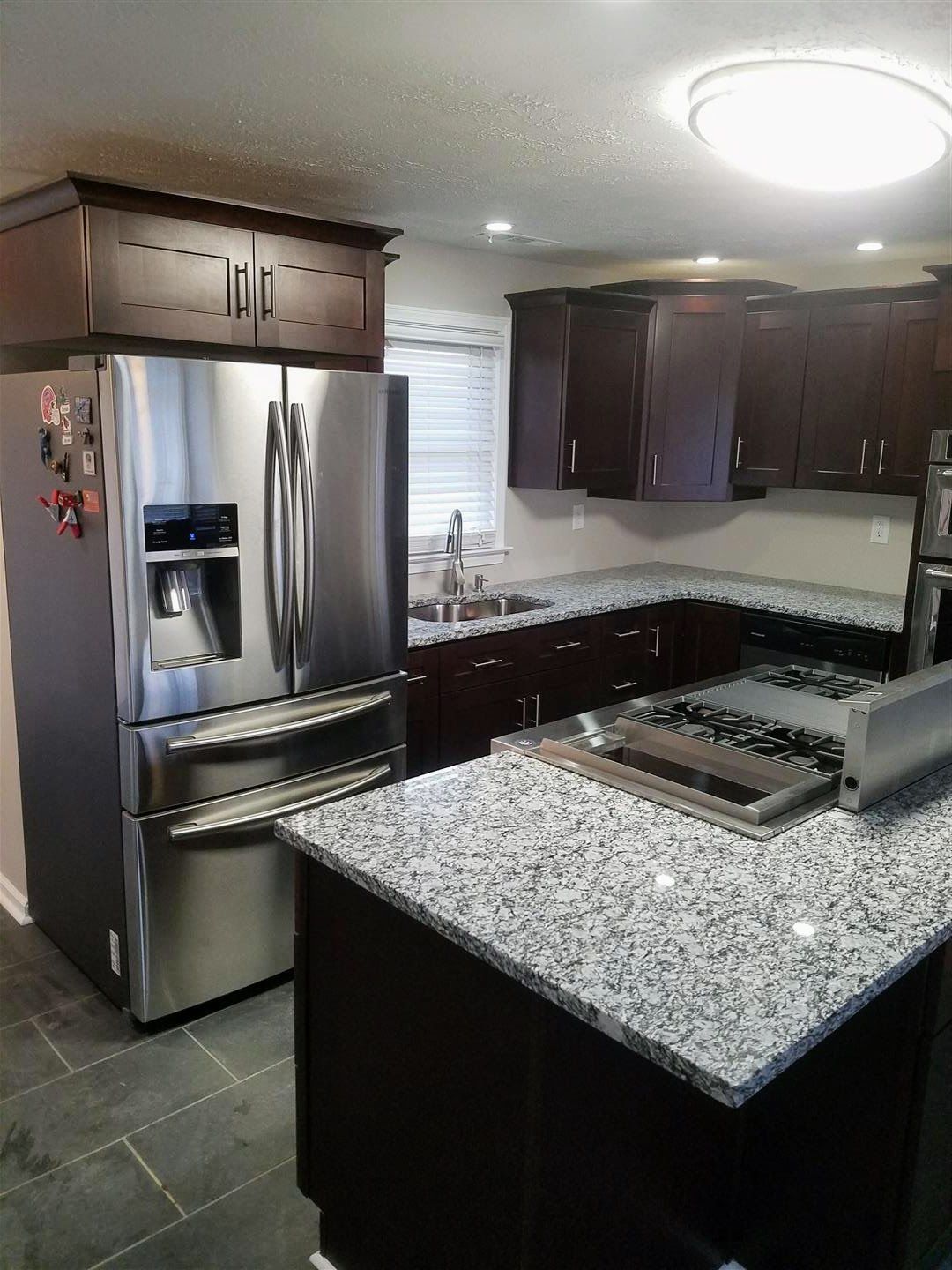 A kitchen with stainless steel appliances and granite counter tops