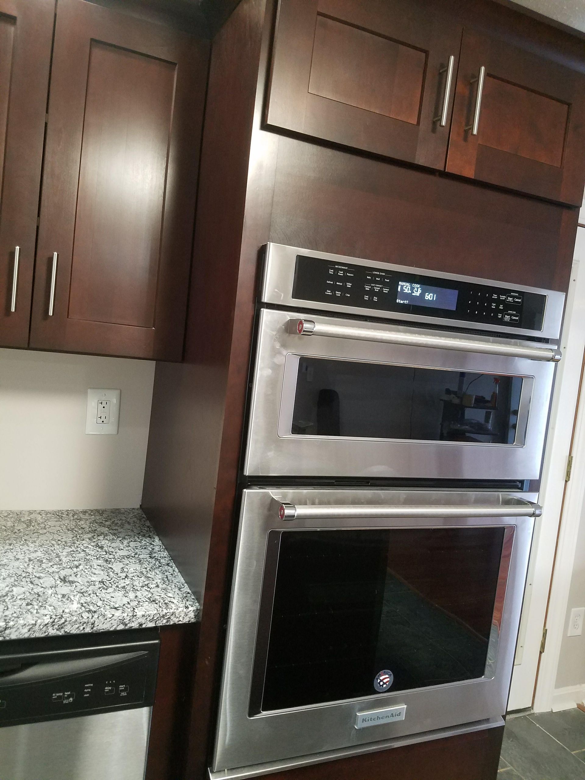 A kitchen with stainless steel appliances and wooden cabinets