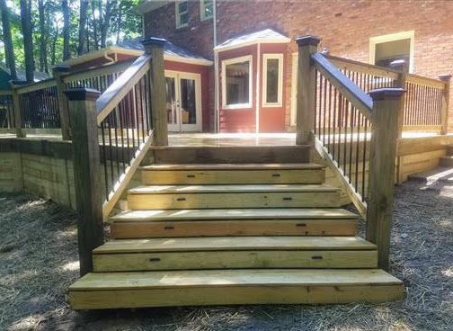 A wooden deck with stairs leading up to it