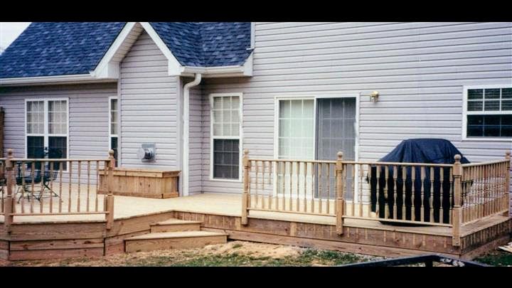 A house with a wooden deck in front of it