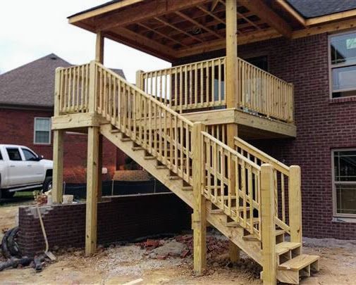 A wooden deck with stairs leading up to it