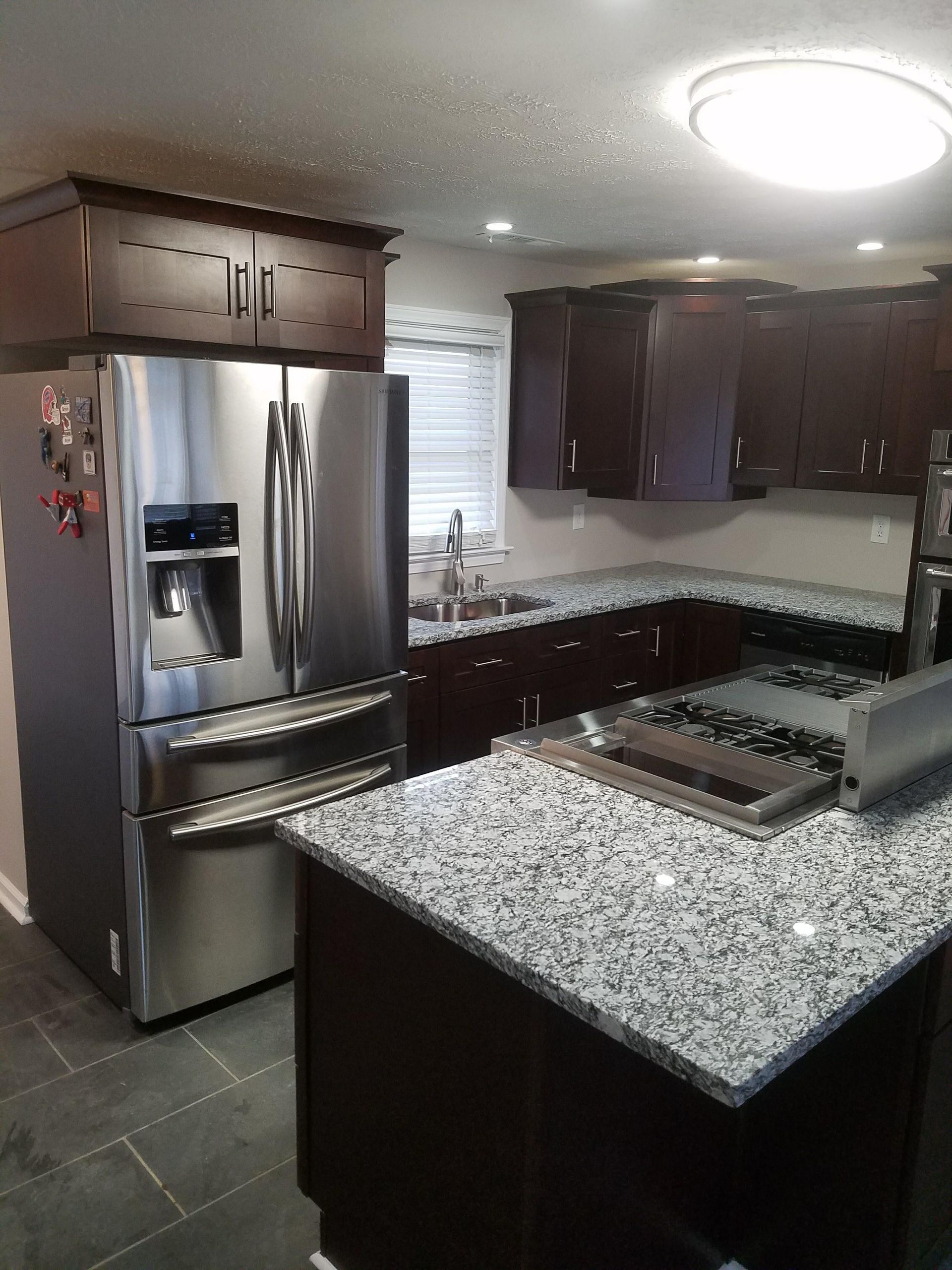 A kitchen with stainless steel appliances and granite counter tops