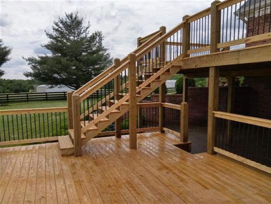 A wooden deck with stairs leading up to it