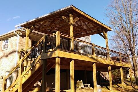 A large wooden deck with stairs leading up to it.