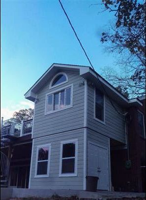A small house with a blue sky in the background