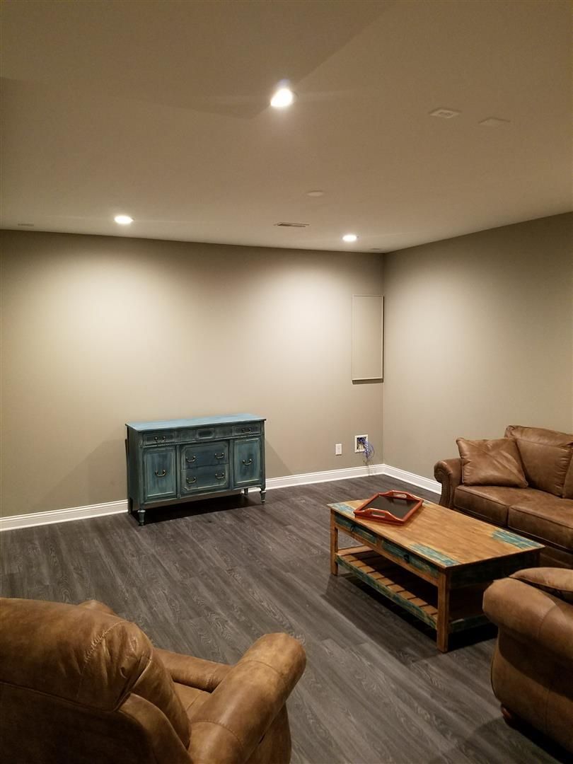 A living room with a couch , chair and coffee table.