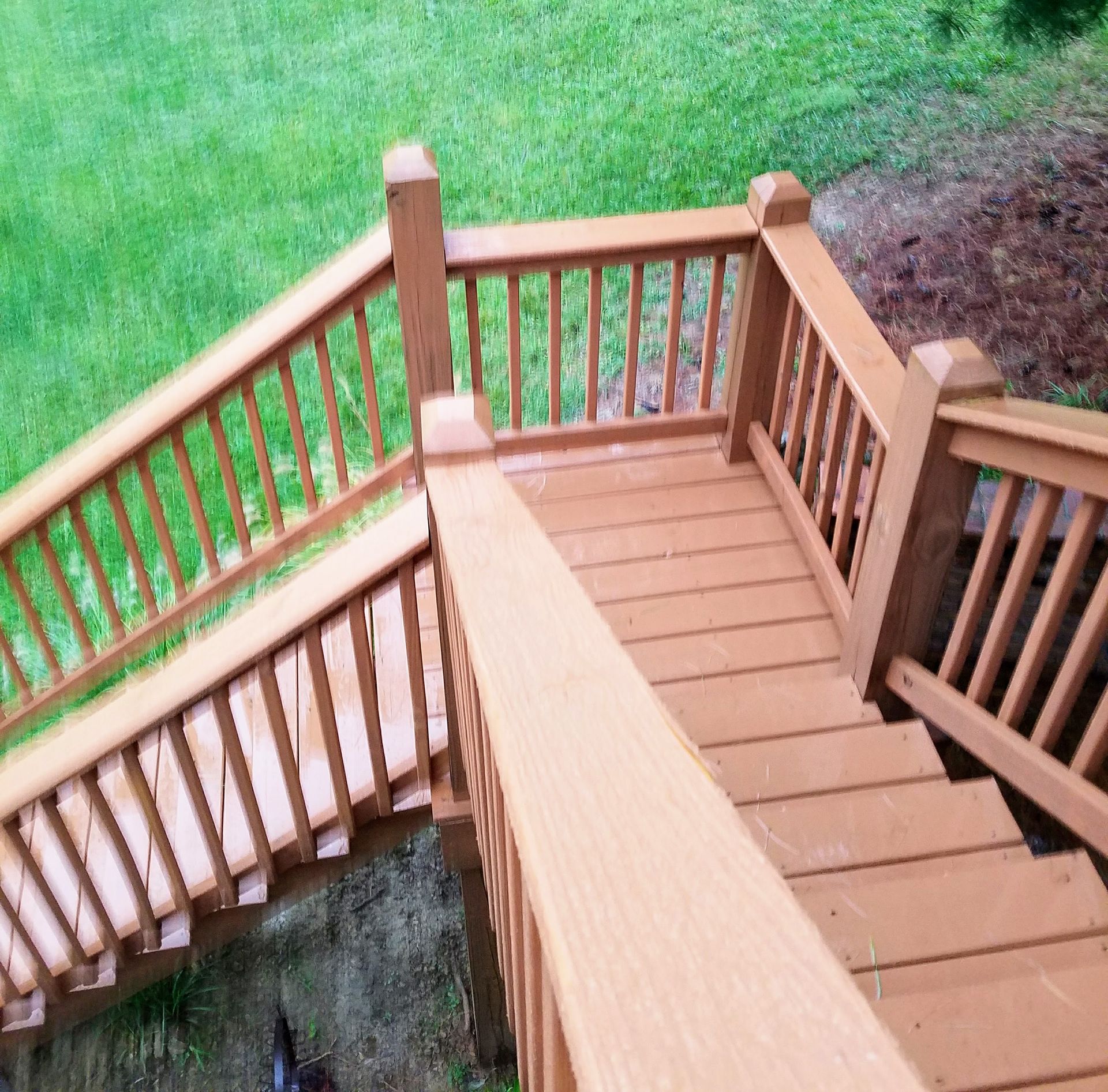 A wooden deck with stairs leading up to it