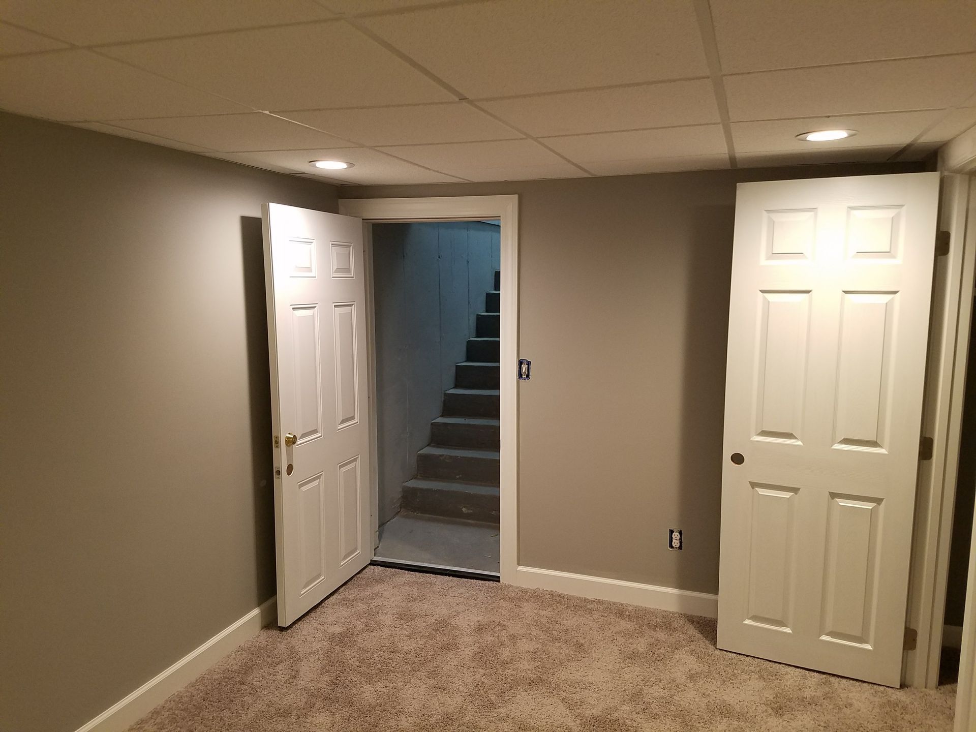 A basement with a staircase leading up to the second floor.