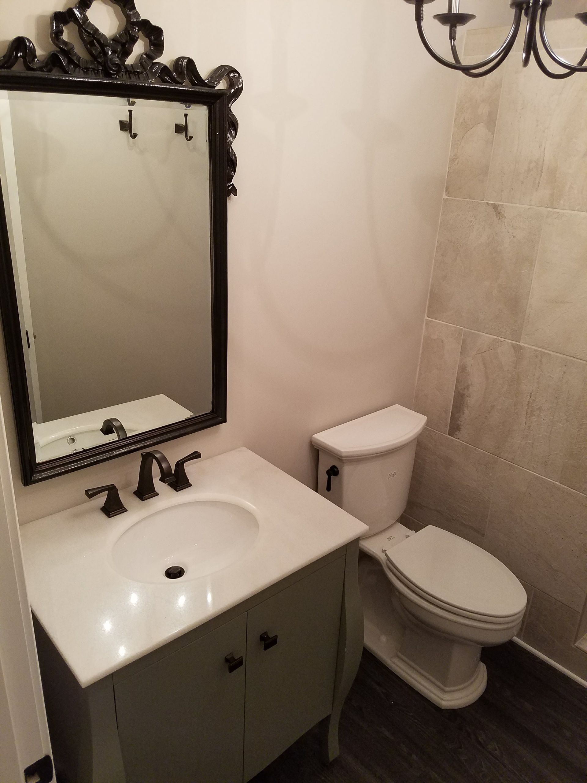 A bathroom with a sink , toilet and mirror