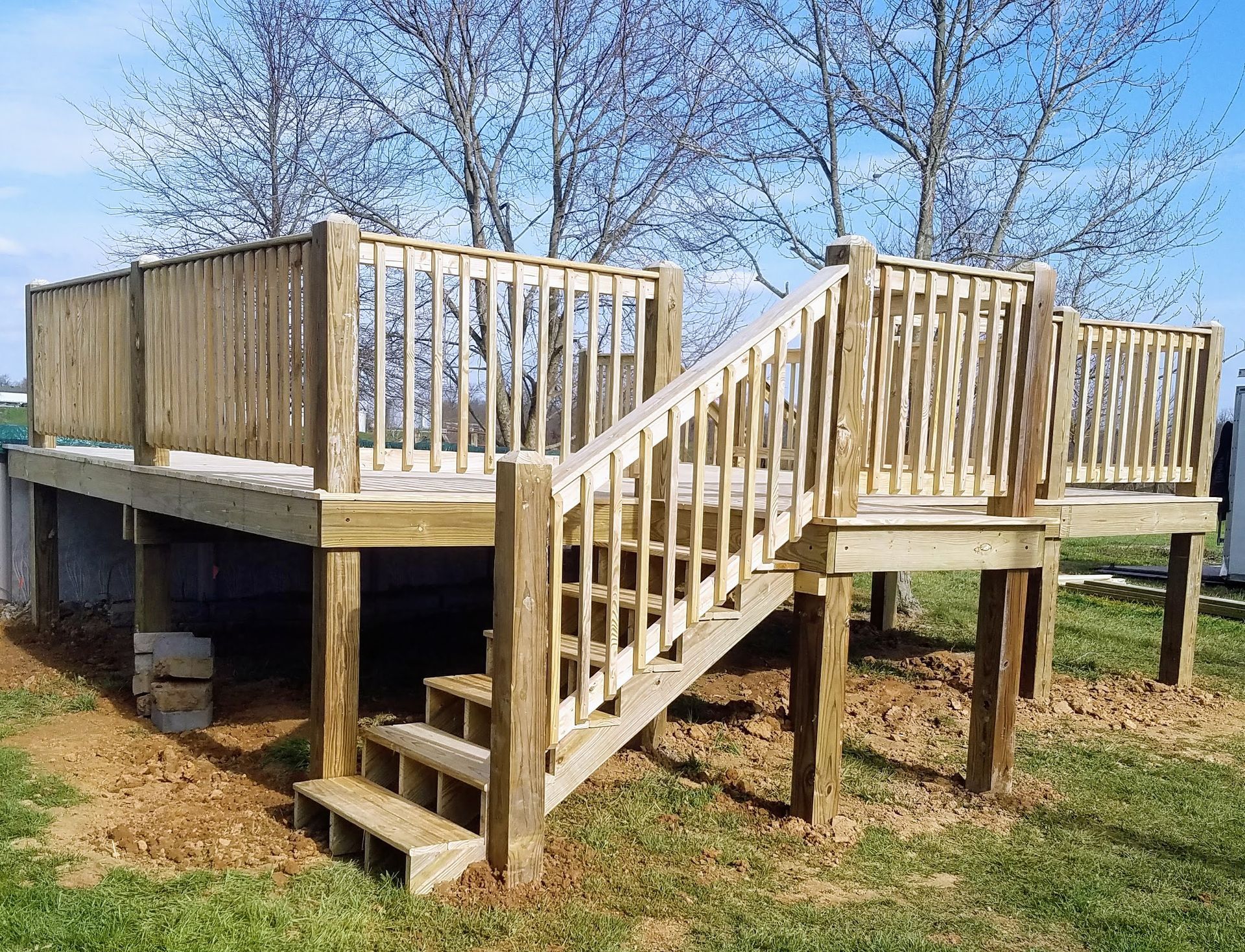 A wooden deck with stairs leading up to it