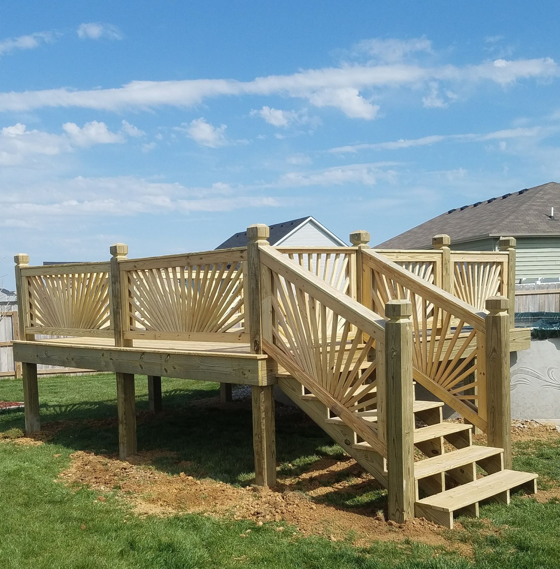 A wooden deck with stairs leading up to it