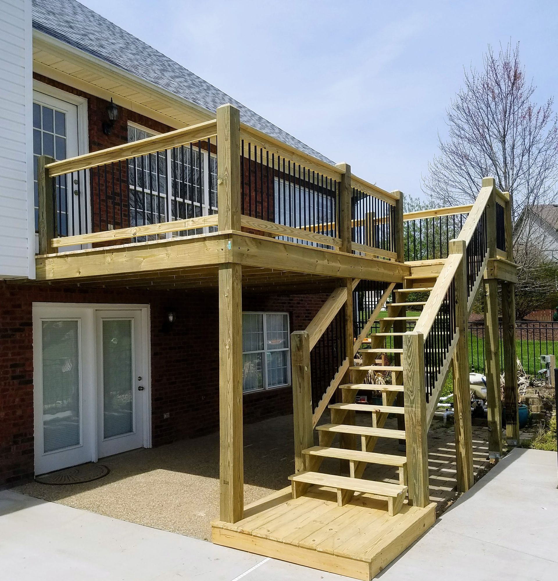 A wooden deck with stairs leading up to it