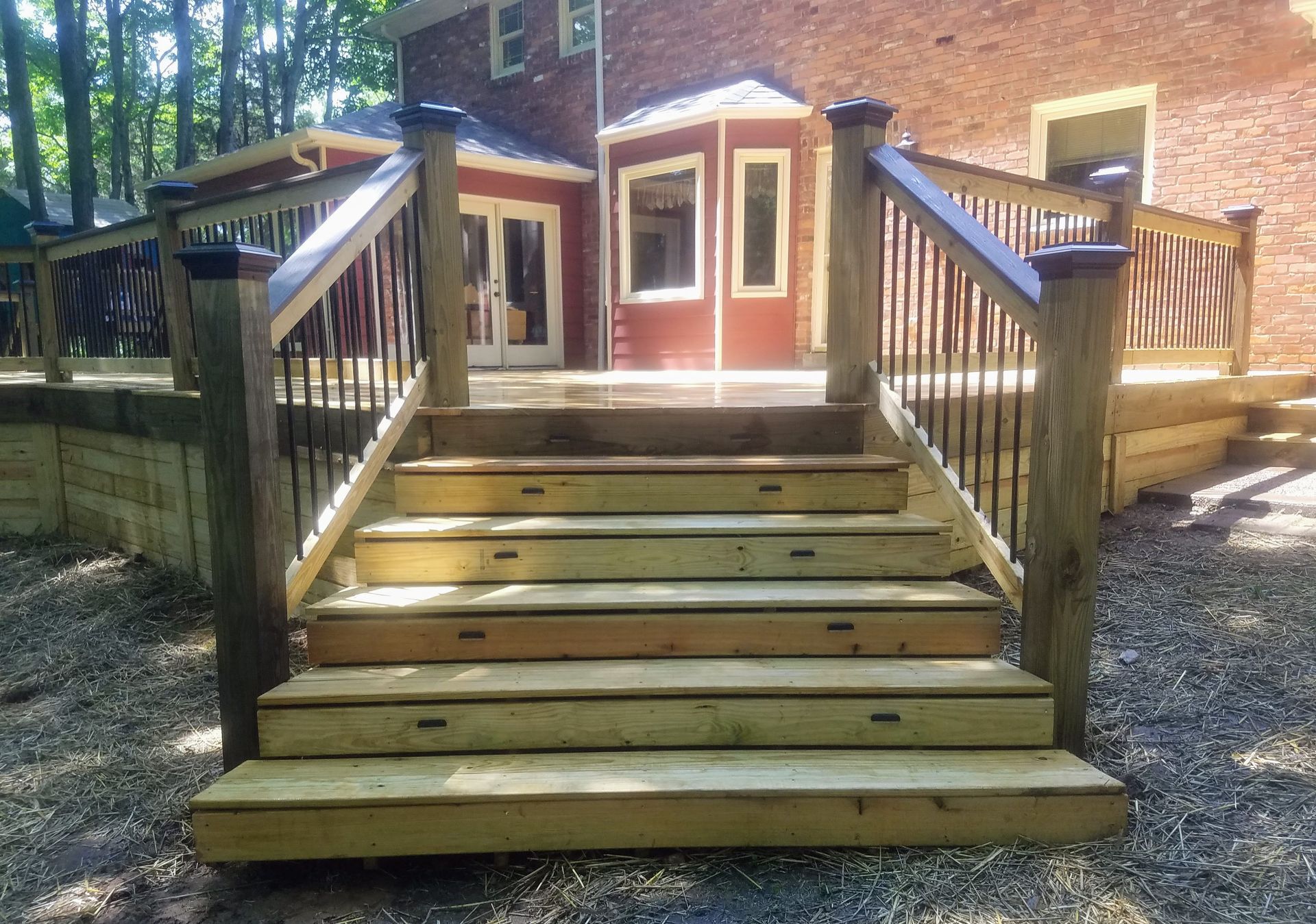 A wooden deck with stairs leading up to it