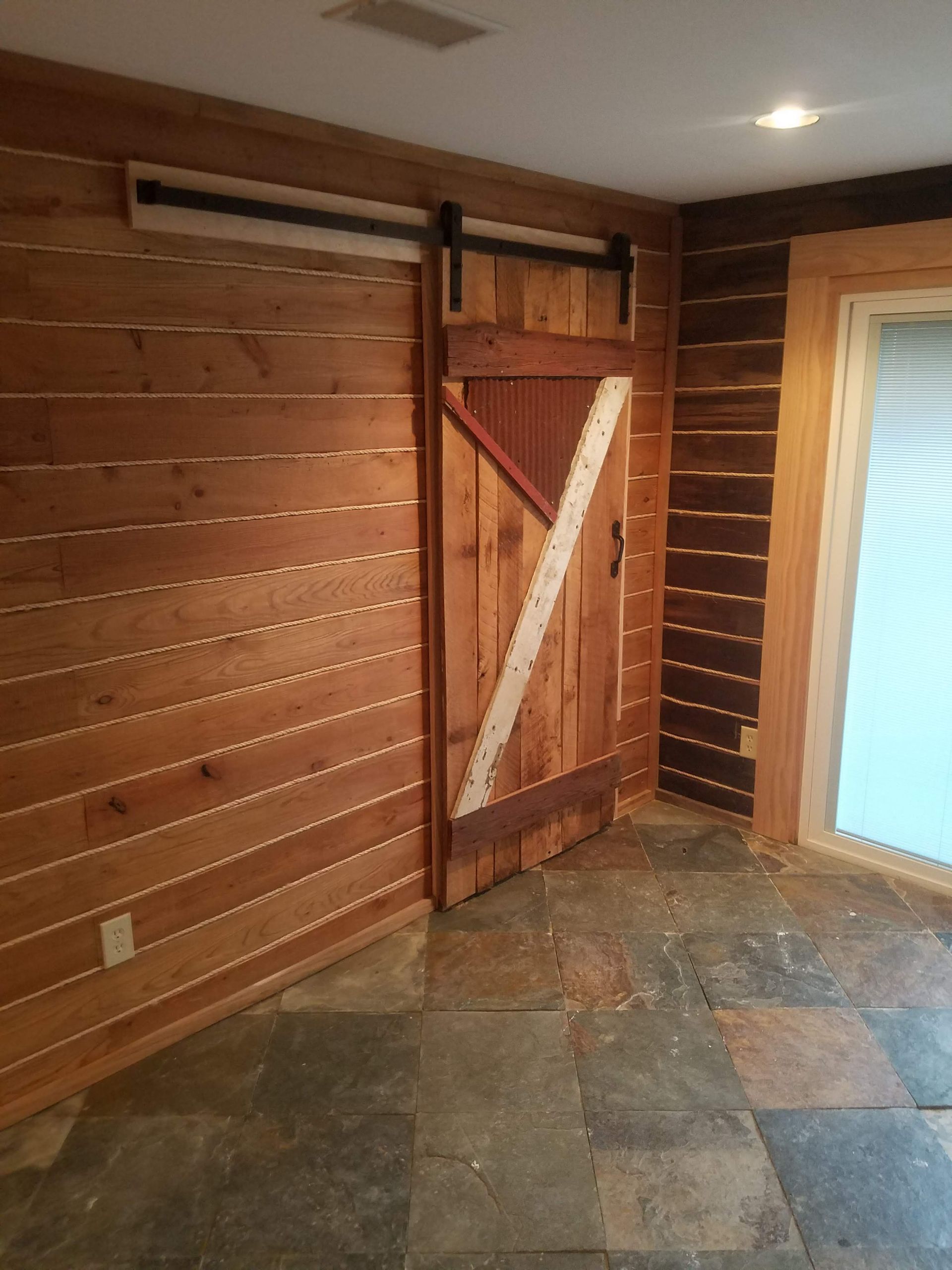 A room with a sliding barn door on the wall
