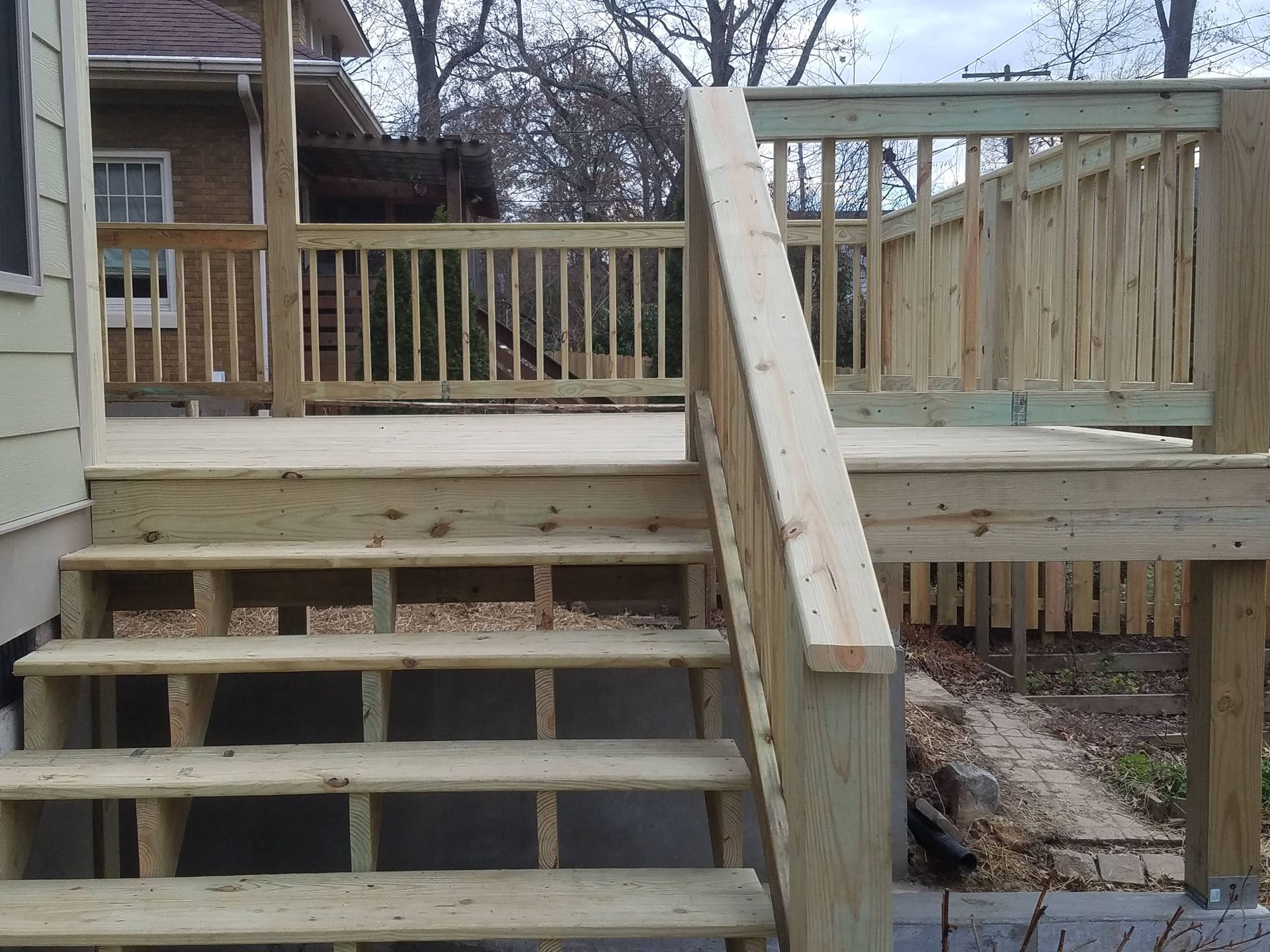 A wooden deck with stairs leading up to it