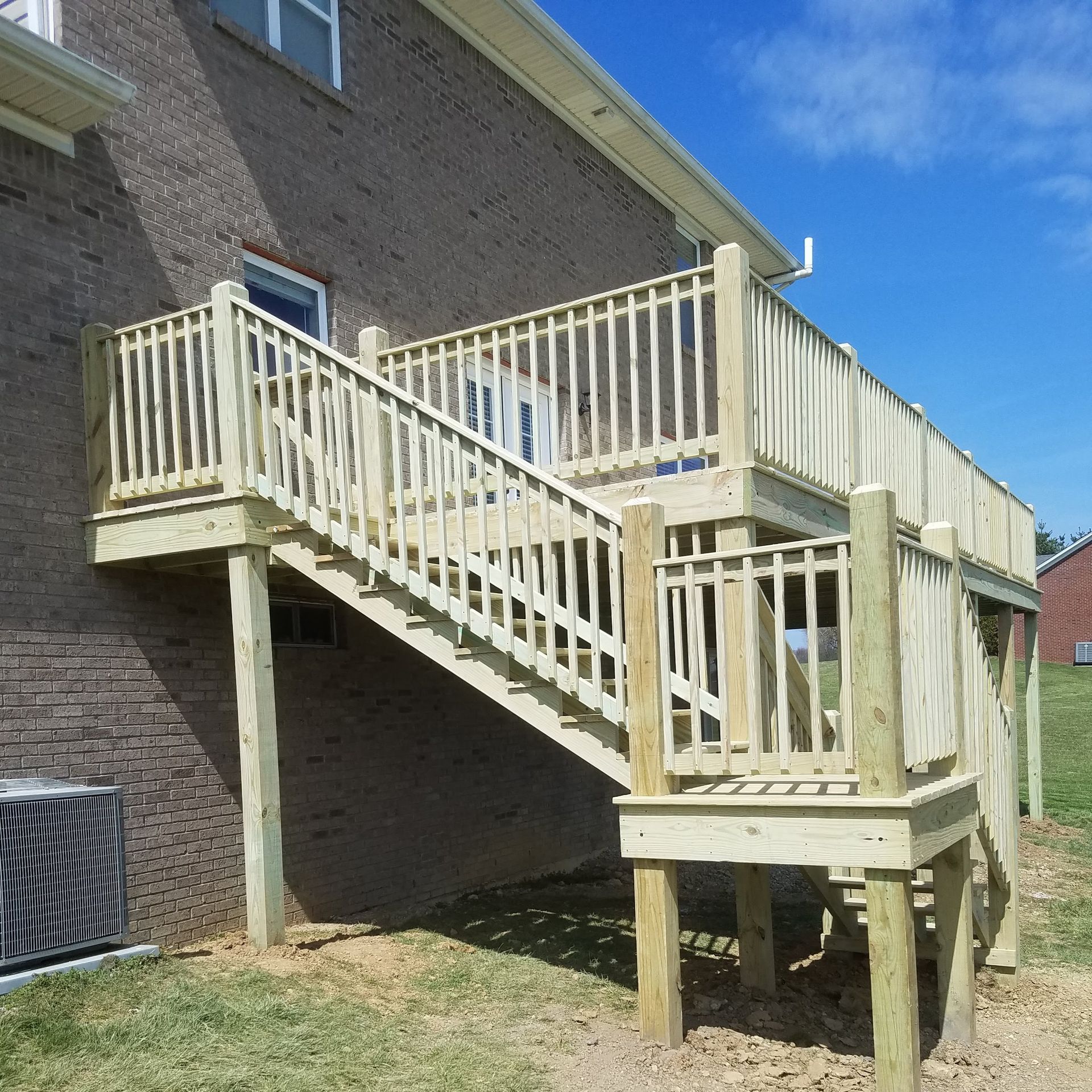 A wooden deck with stairs leading up to it
