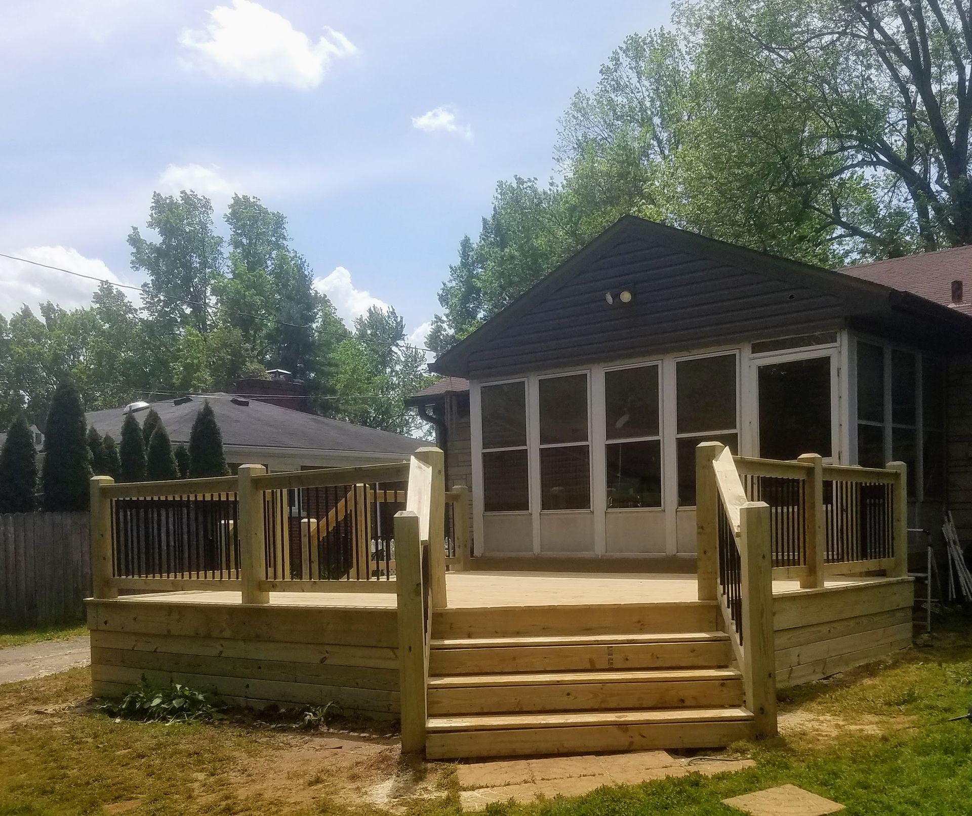 A screened in porch with stairs leading up to it
