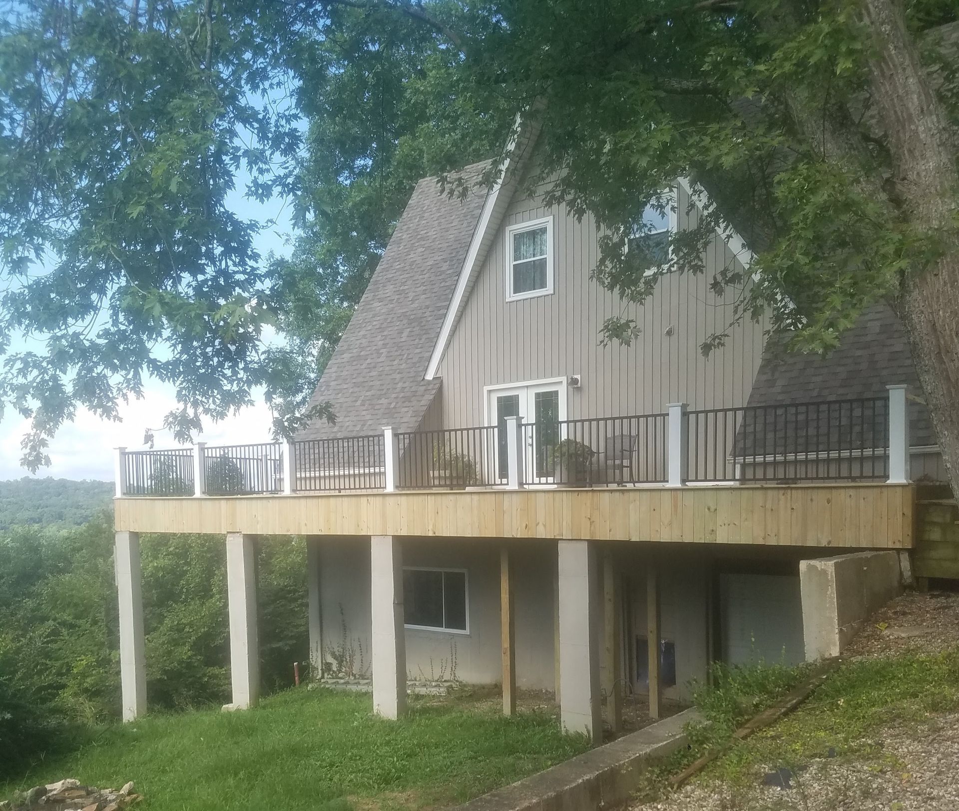 A house with a large deck on top of it