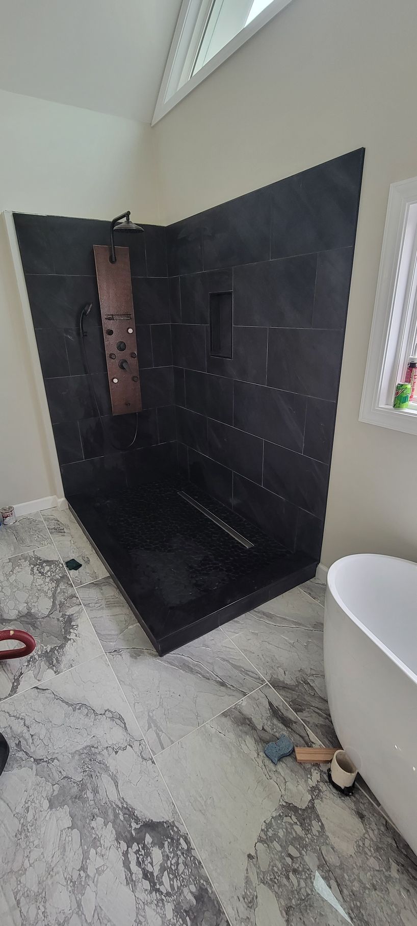 A bathroom with a walk in shower and a bathtub.