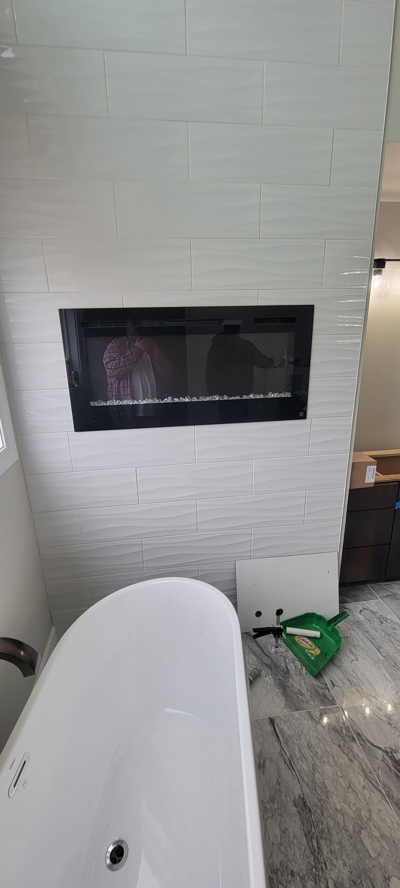 A bathroom with a fireplace and a bathtub.