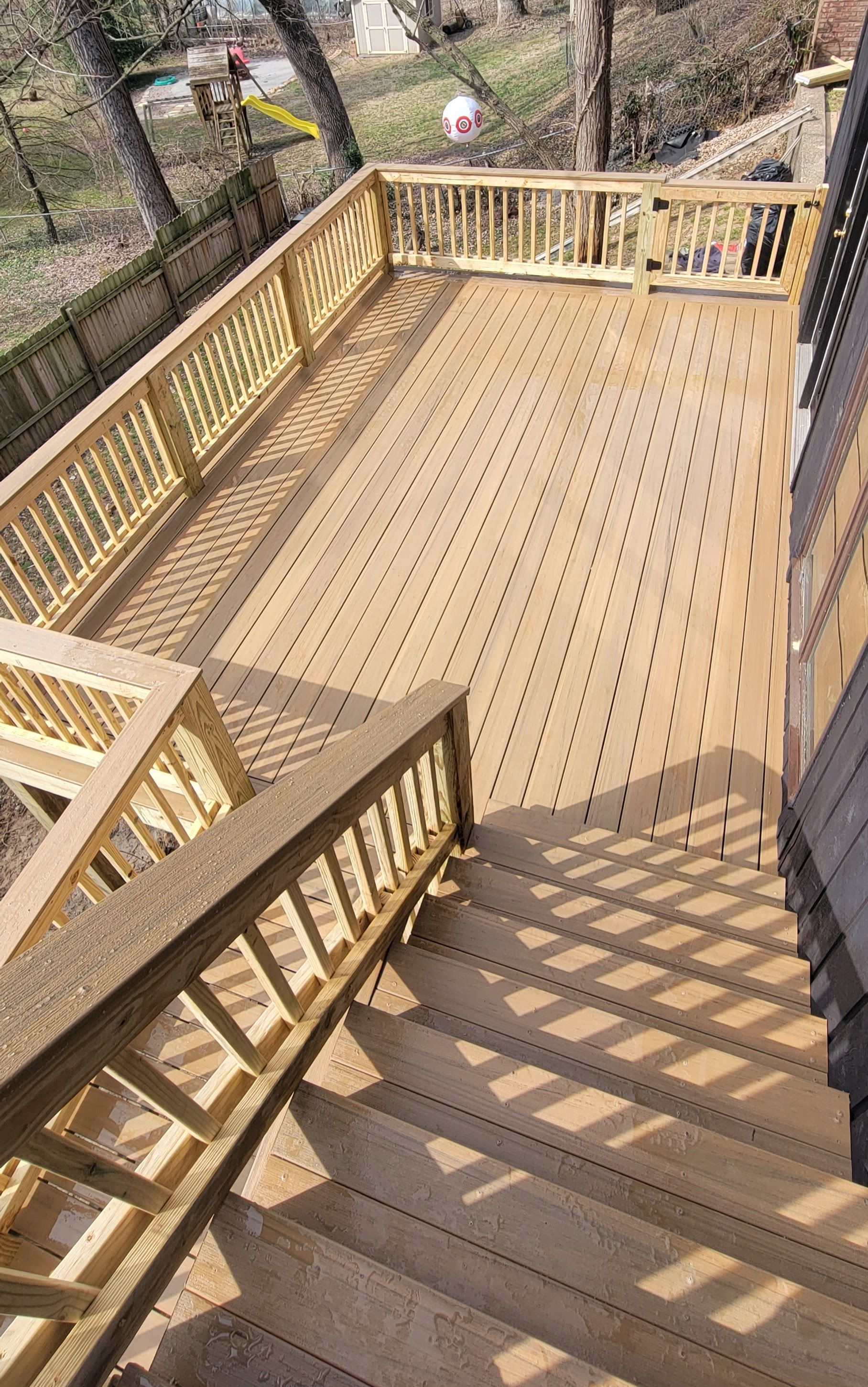 A wooden deck with stairs leading up to it.