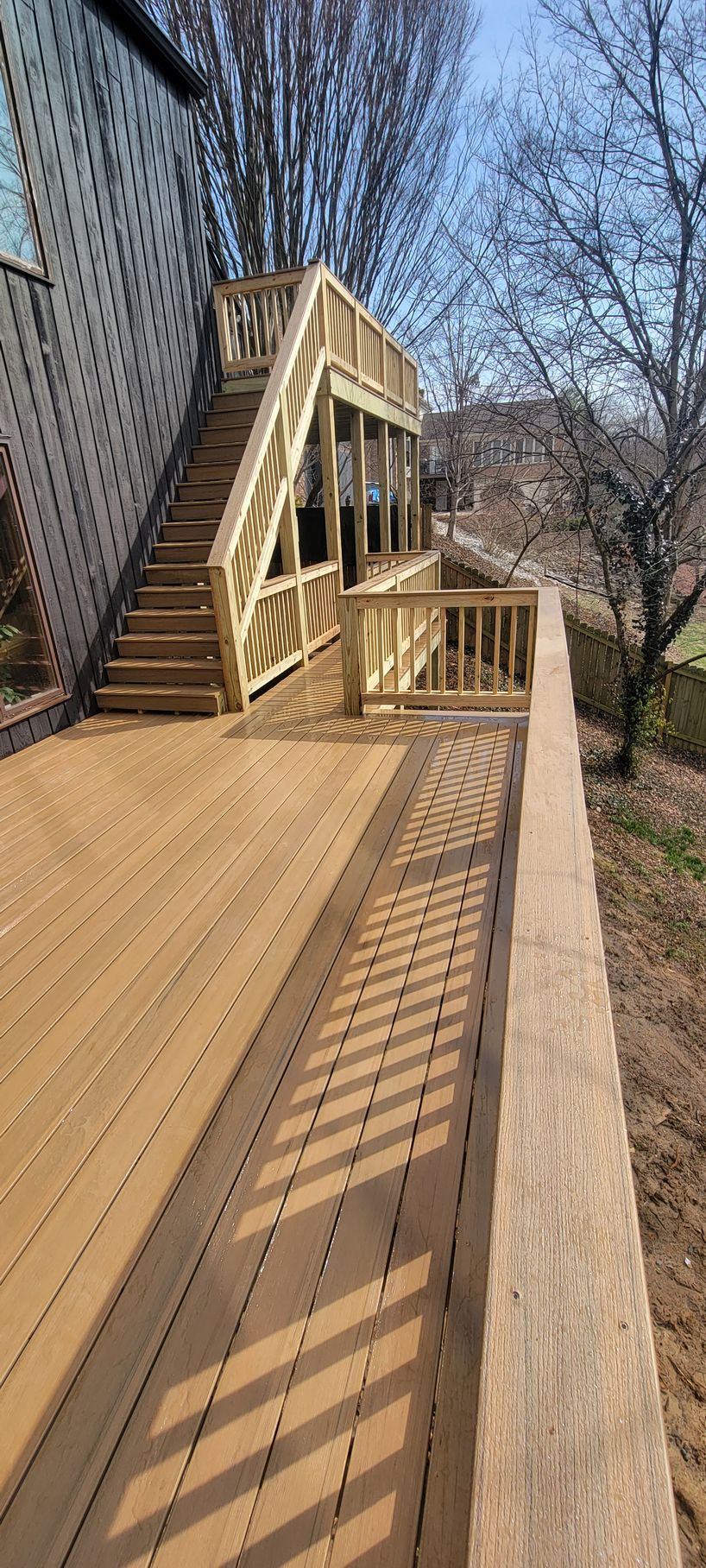 A wooden deck with stairs leading up to it.