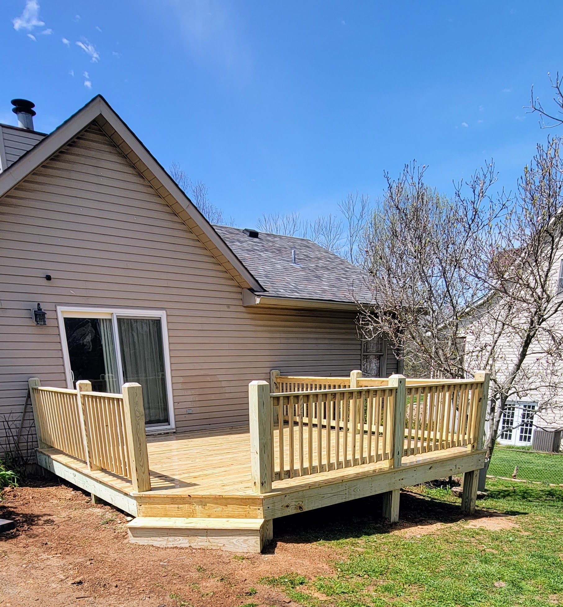 A house with a wooden deck in front of it