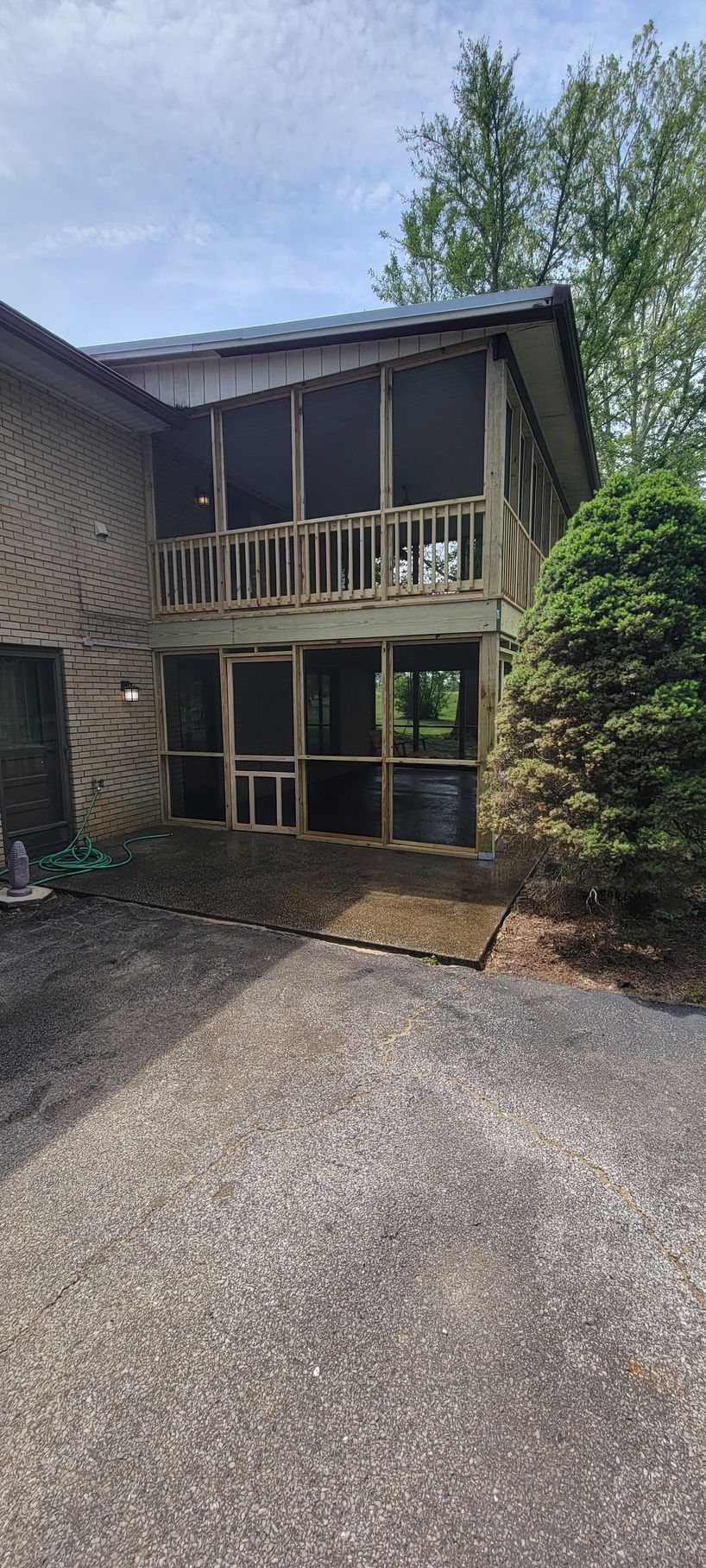 A house with a screened in porch and a garage.