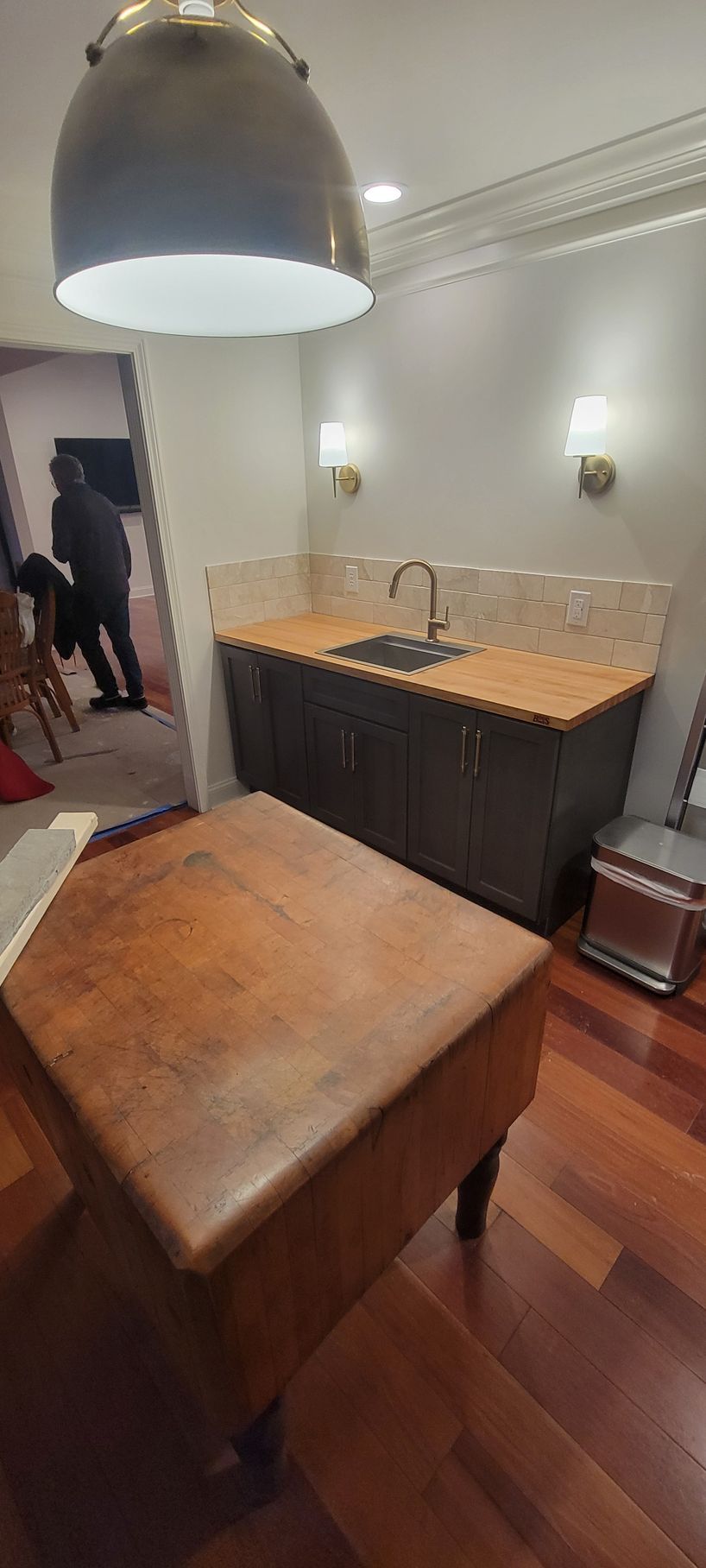 A kitchen with a wooden table and a sink.