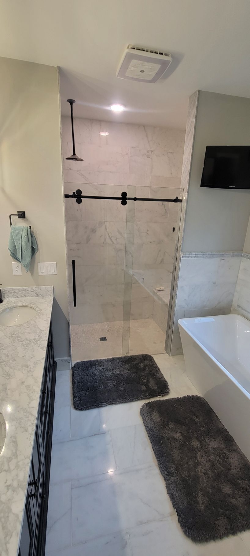 A bathroom with a walk in shower and a bathtub.