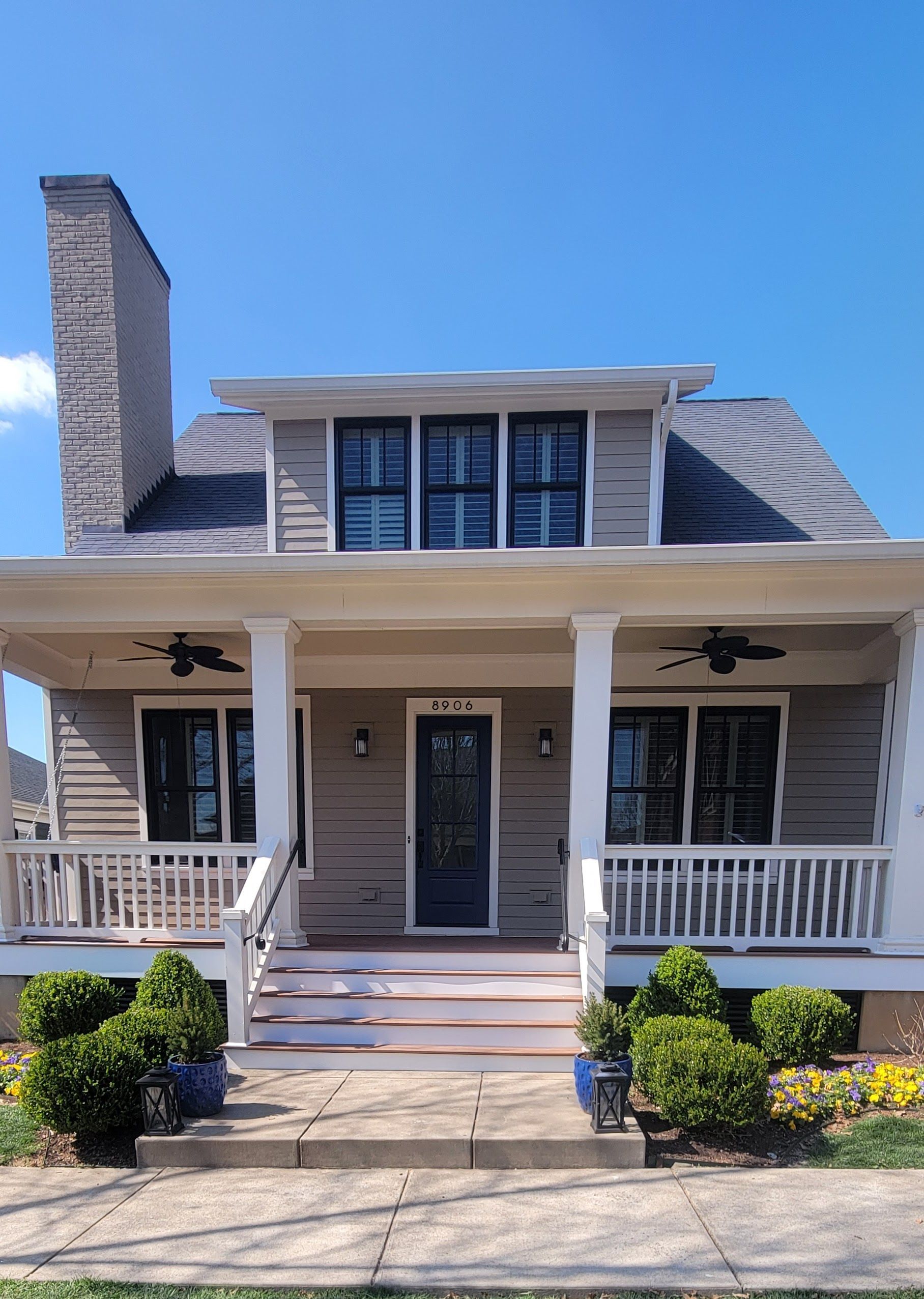 A house with a large porch and a chimney