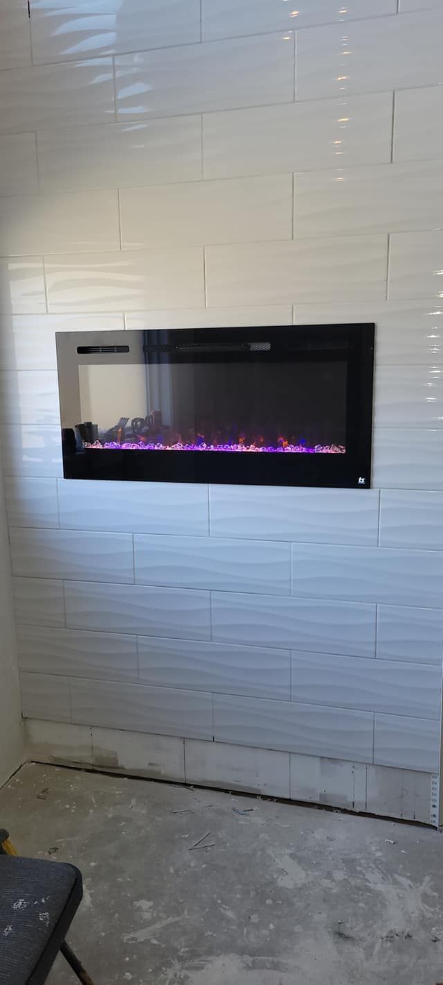 A fireplace is hanging on a white tiled wall in a room.