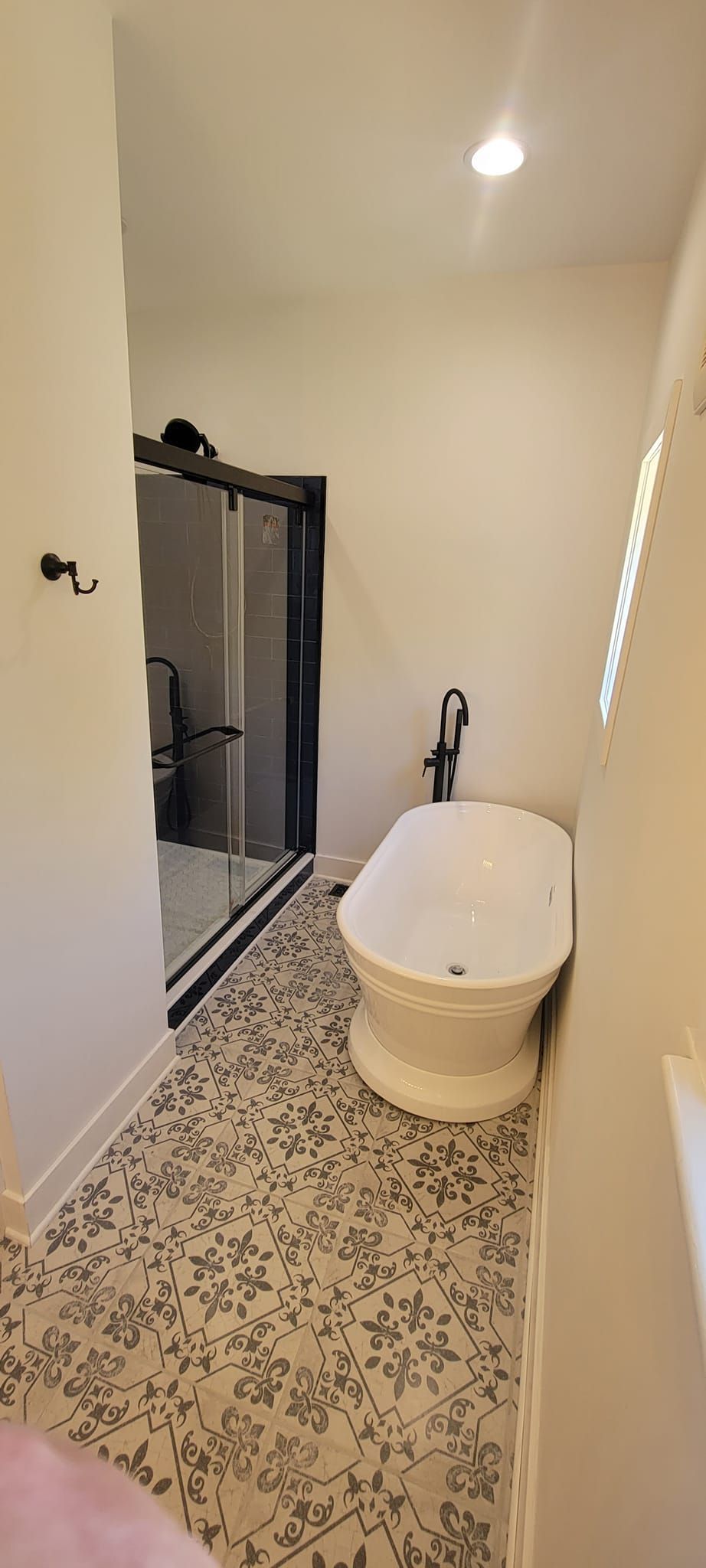 A bathroom with a bathtub , toilet and shower.