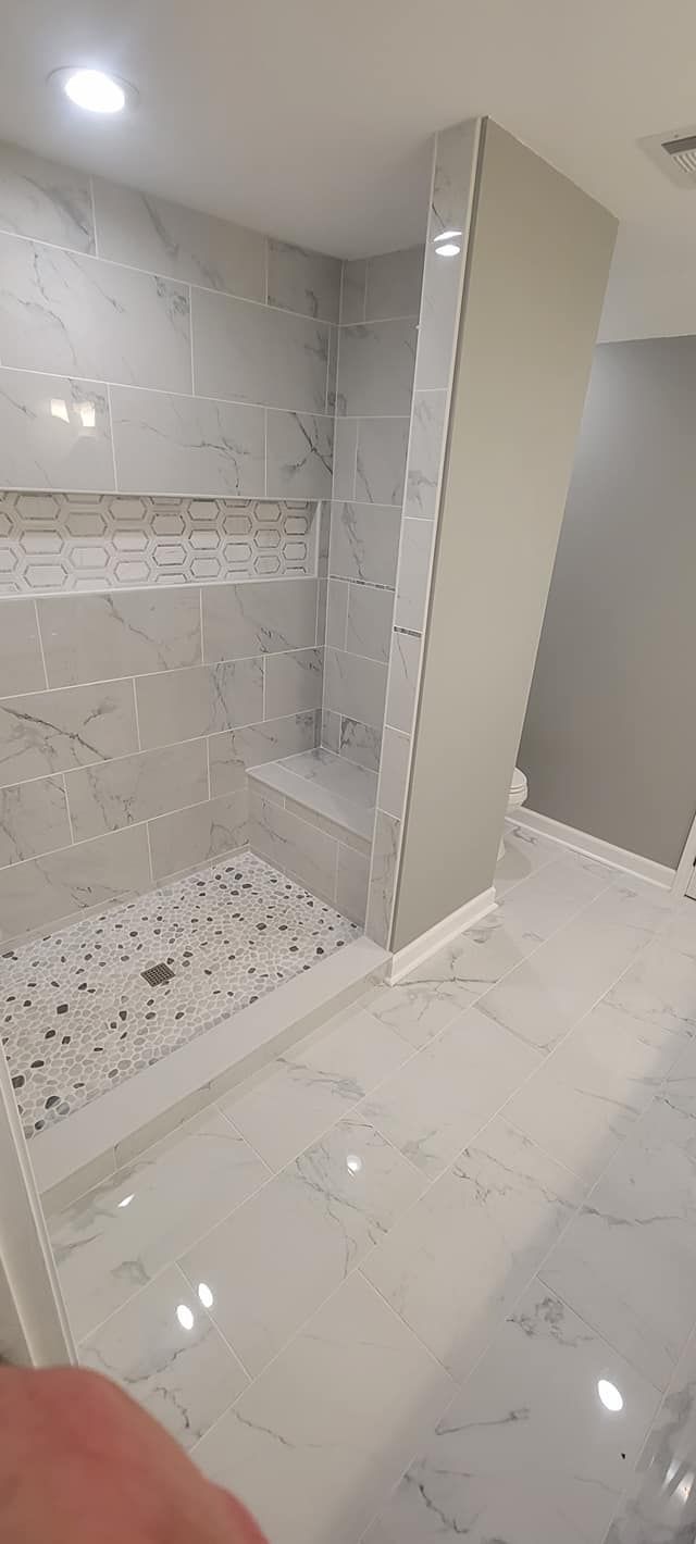 A bathroom with a walk in shower and a bathtub.