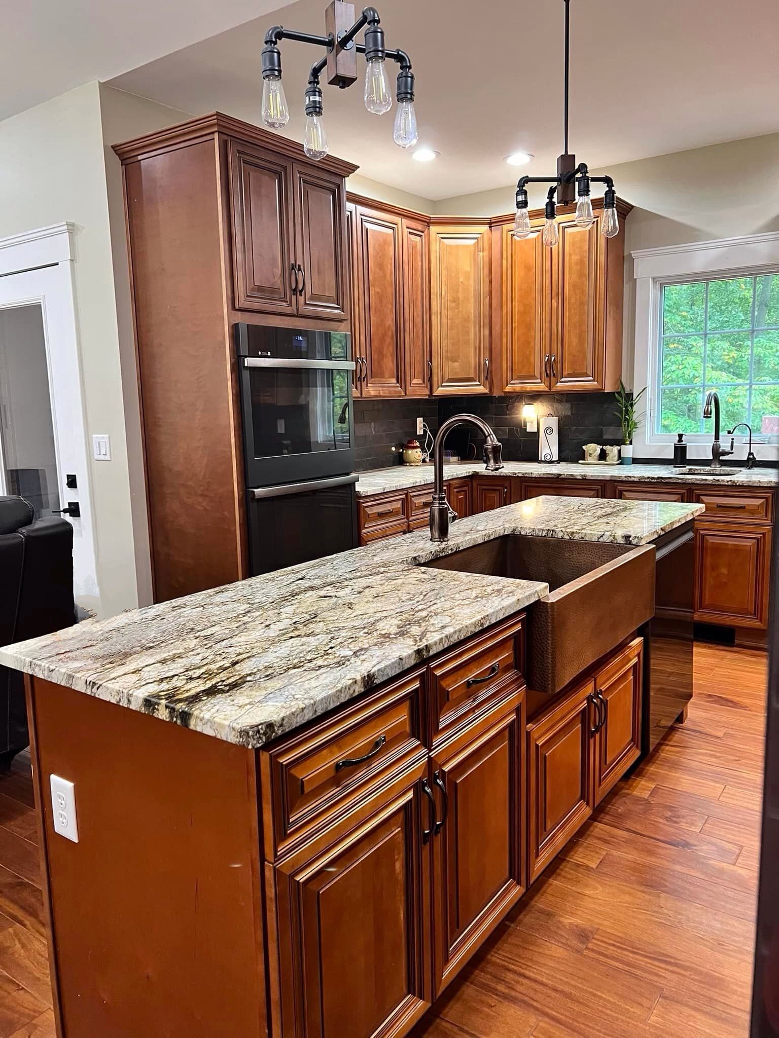 A kitchen with wooden cabinets and granite counter tops
