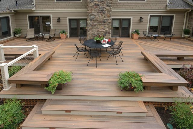 A wooden deck with a table and chairs on it