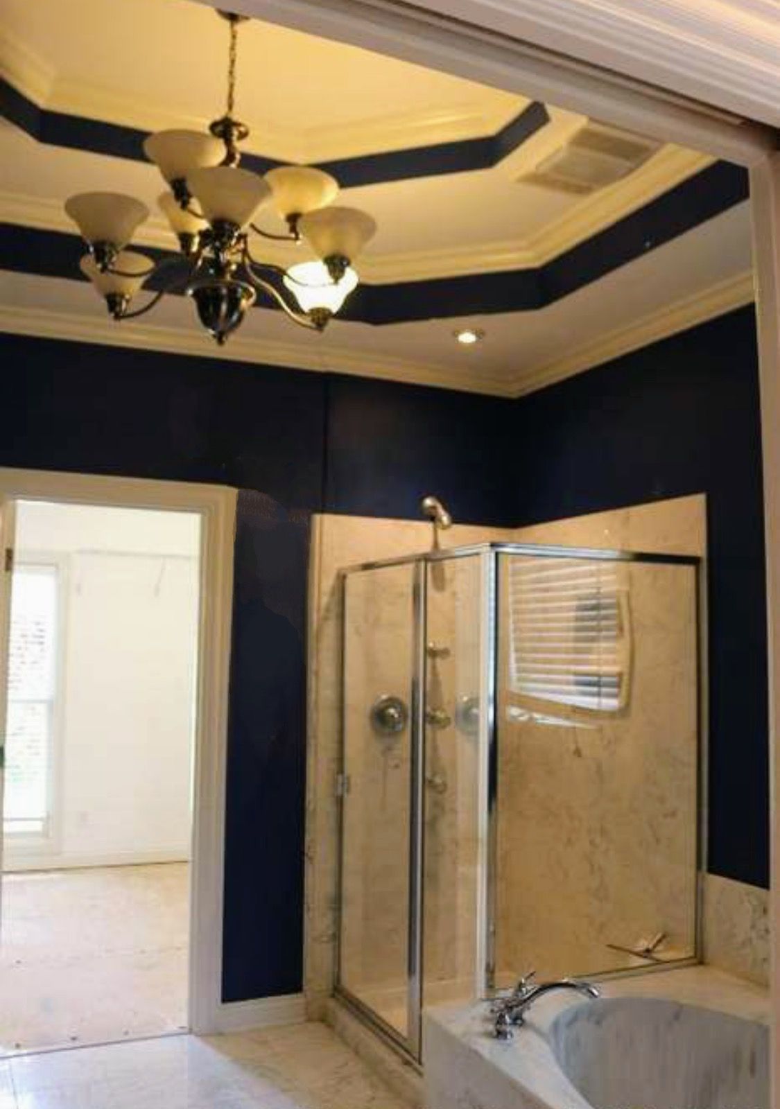 A bathroom with blue walls and a bathtub