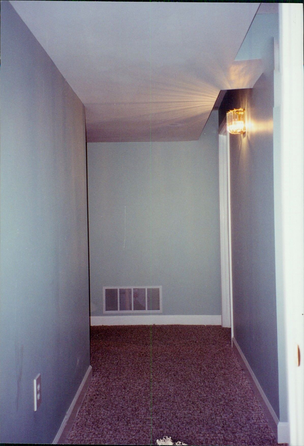 An empty hallway with a light on the ceiling