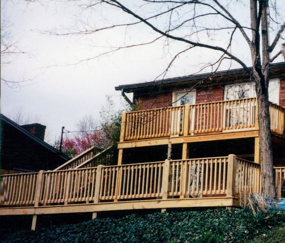 A house with a wooden deck and stairs leading up to it