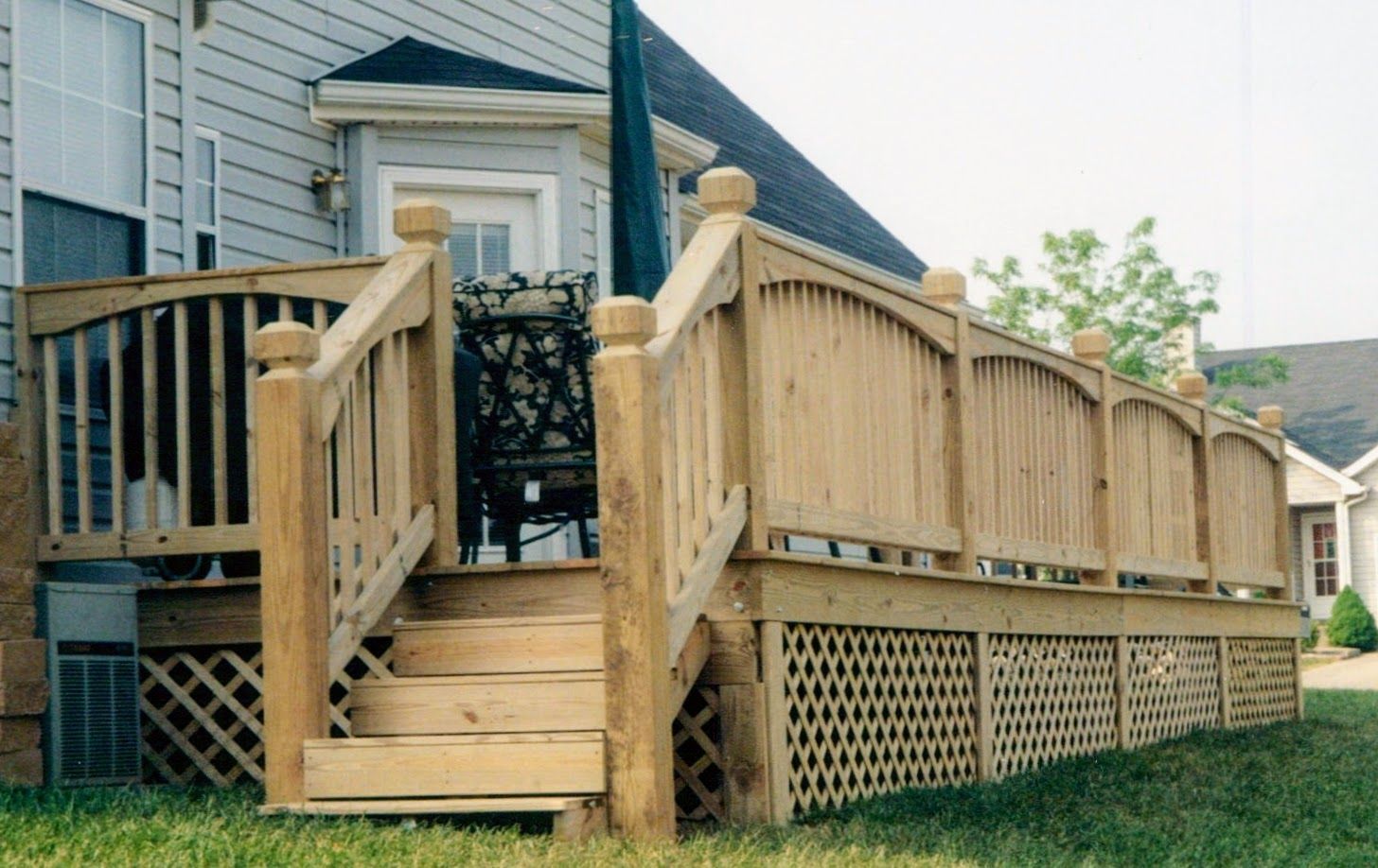 A wooden deck with stairs and a chair on it