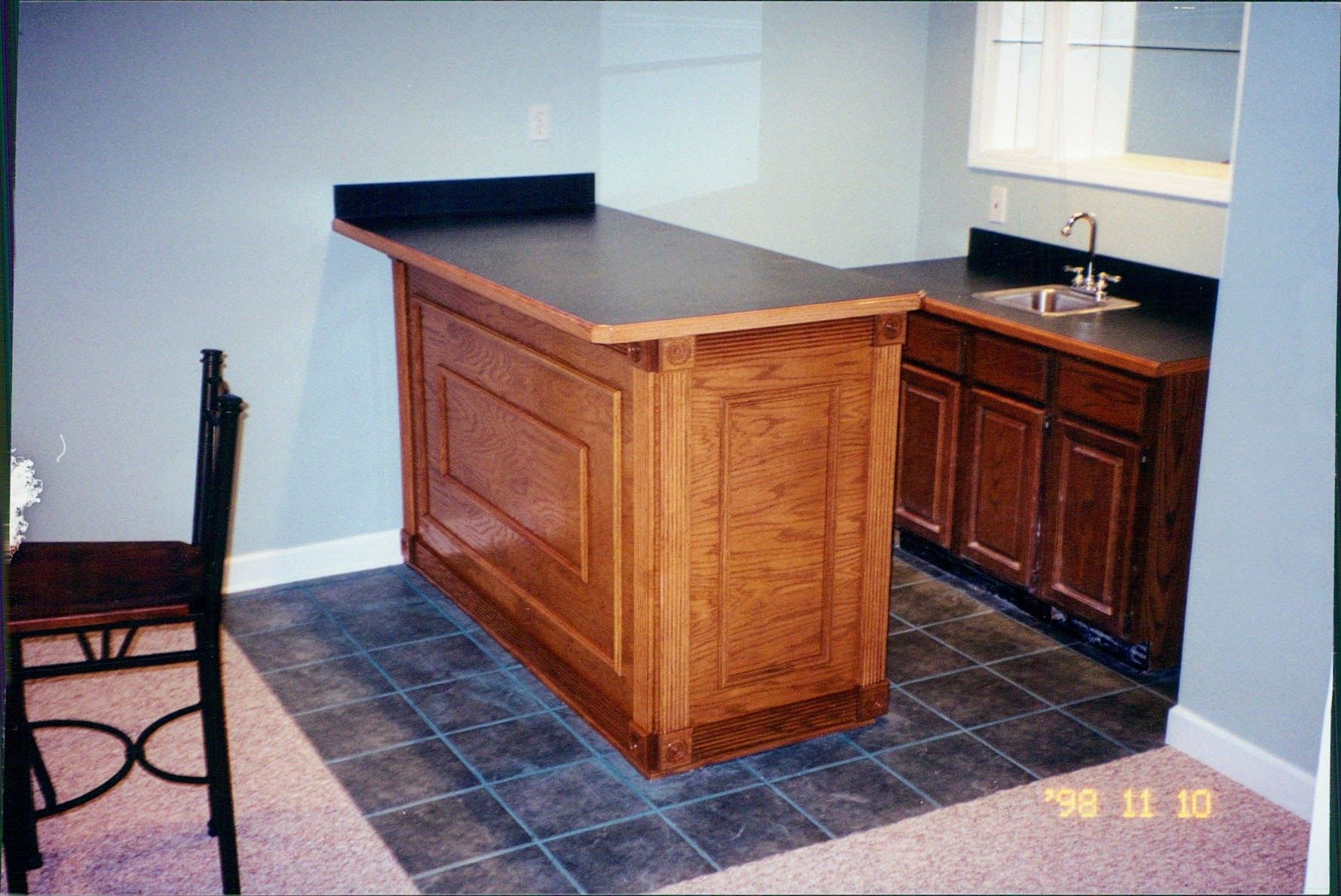 A kitchen with a wooden counter top and a sink