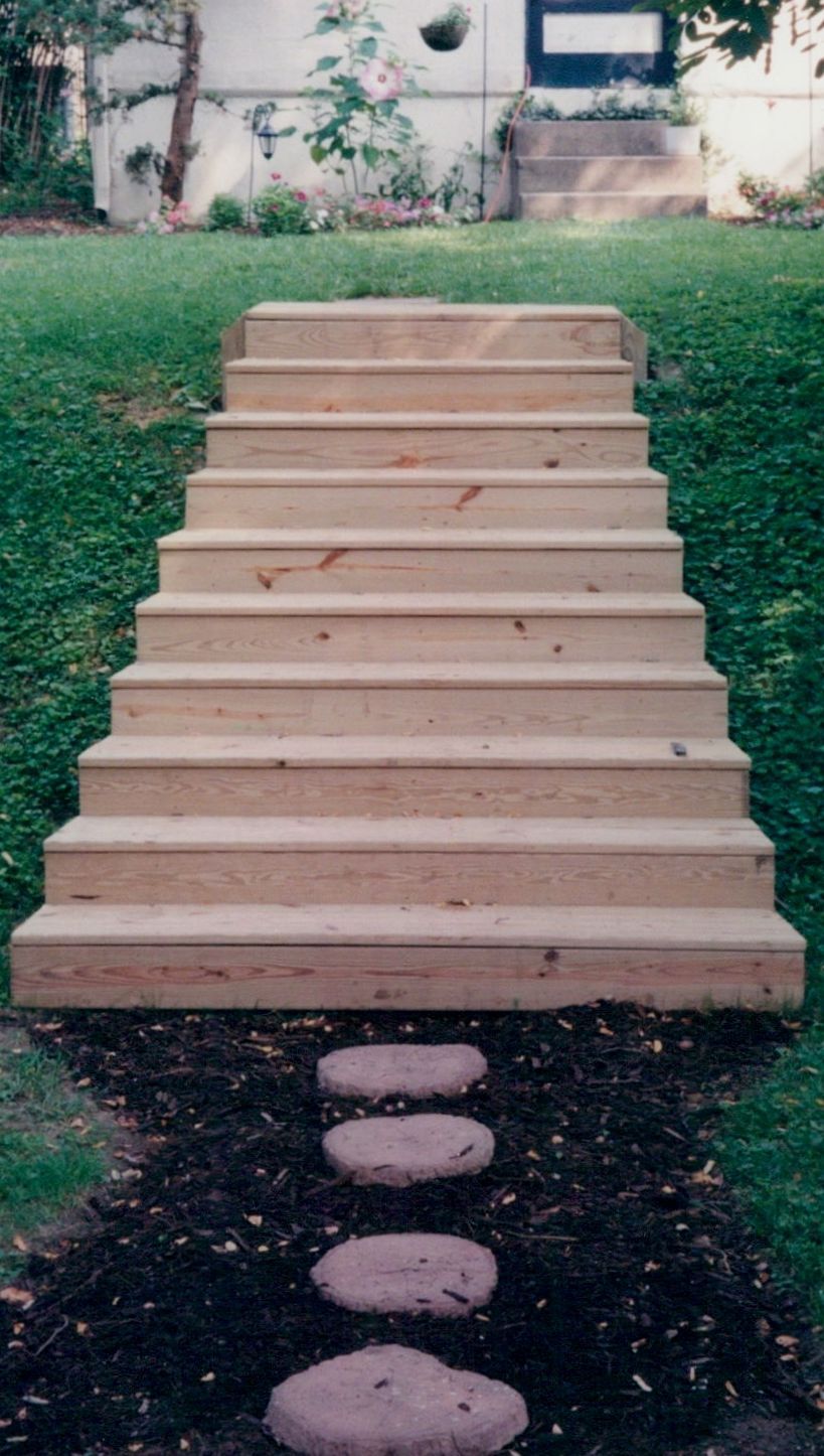 A set of wooden stairs leading up to a house