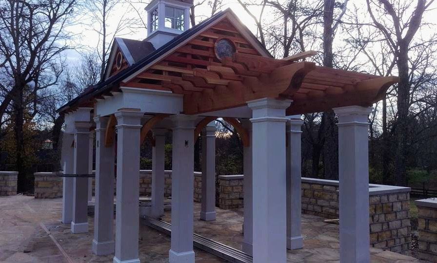 A white building with a wooden roof and columns