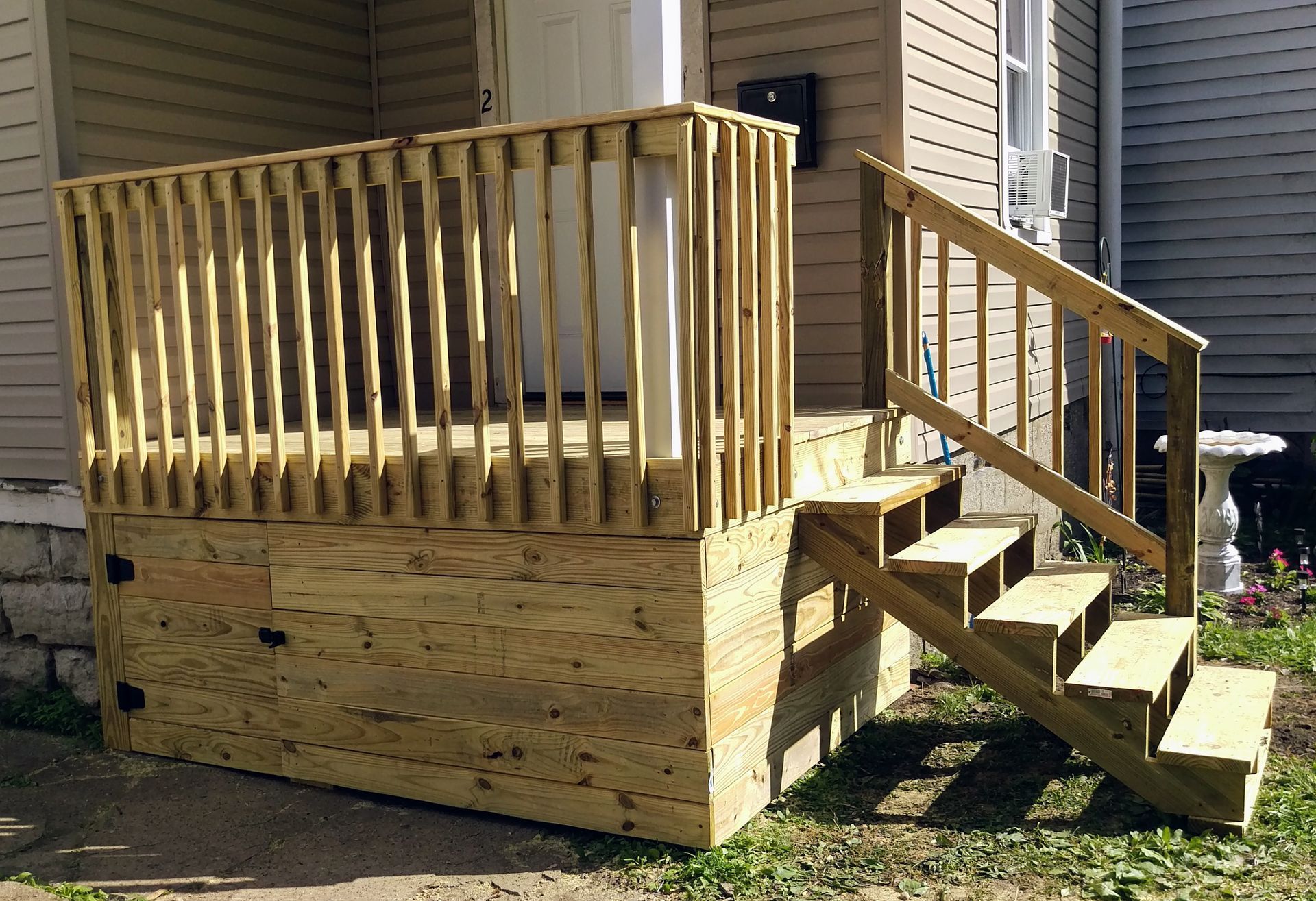 A wooden deck with stairs leading up to it