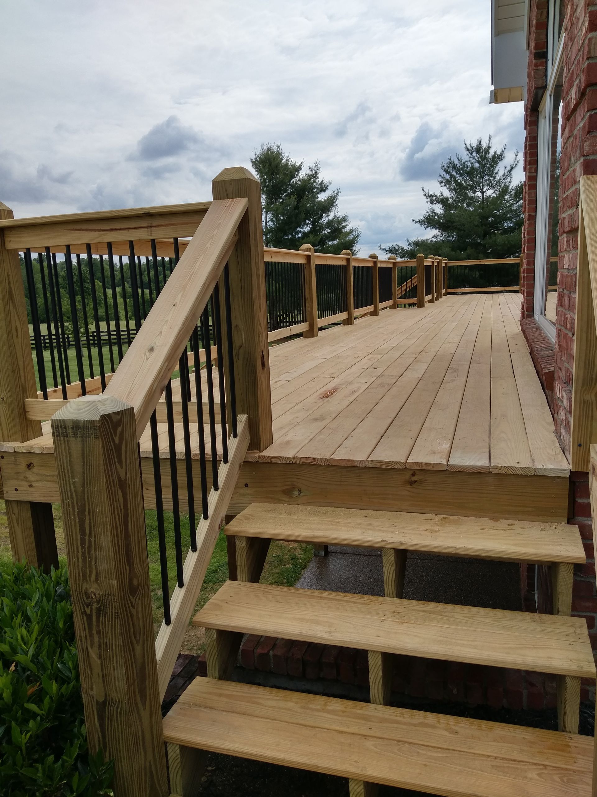 A wooden deck with stairs leading up to it.