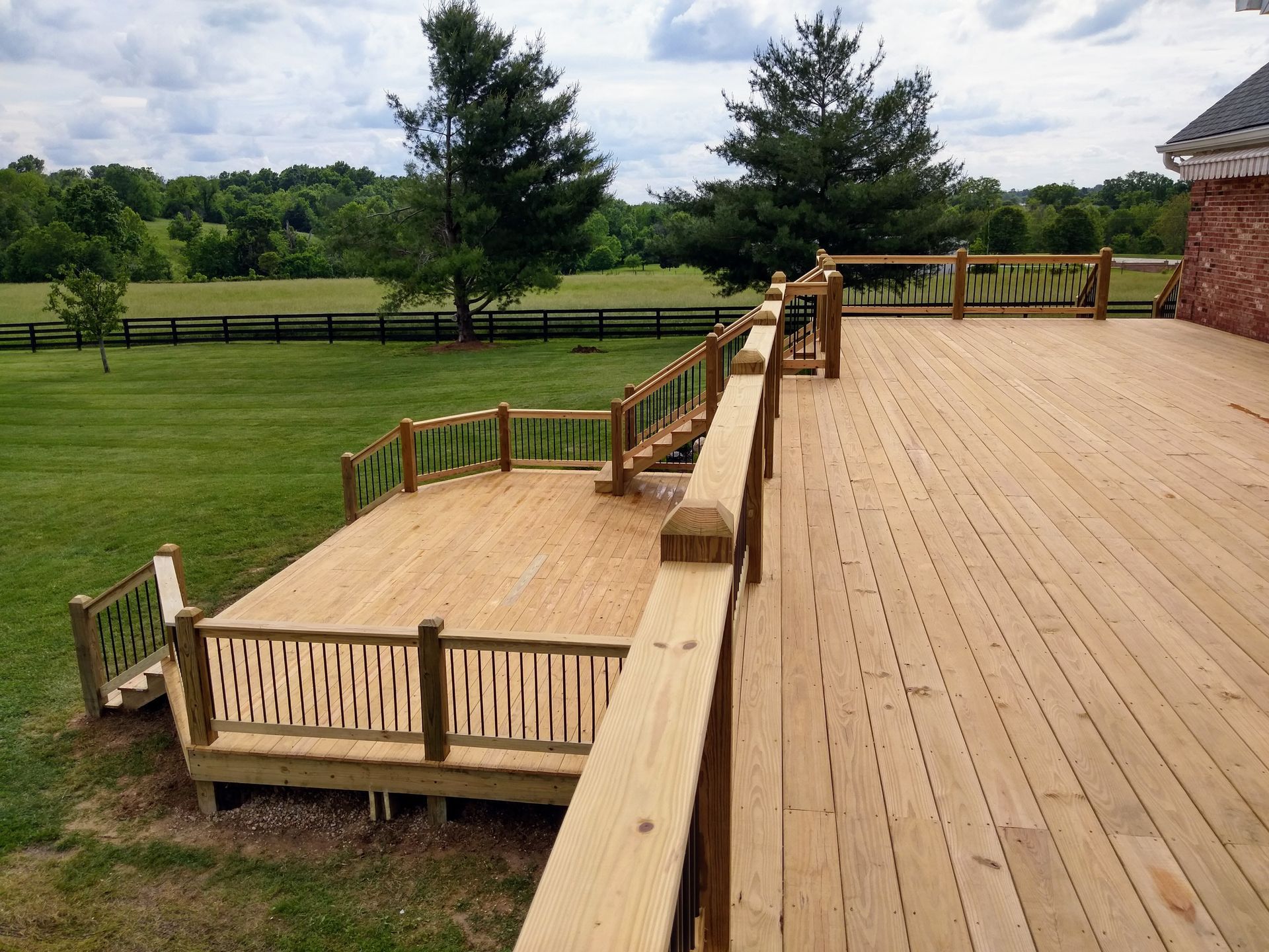 A large wooden deck with a fence around it