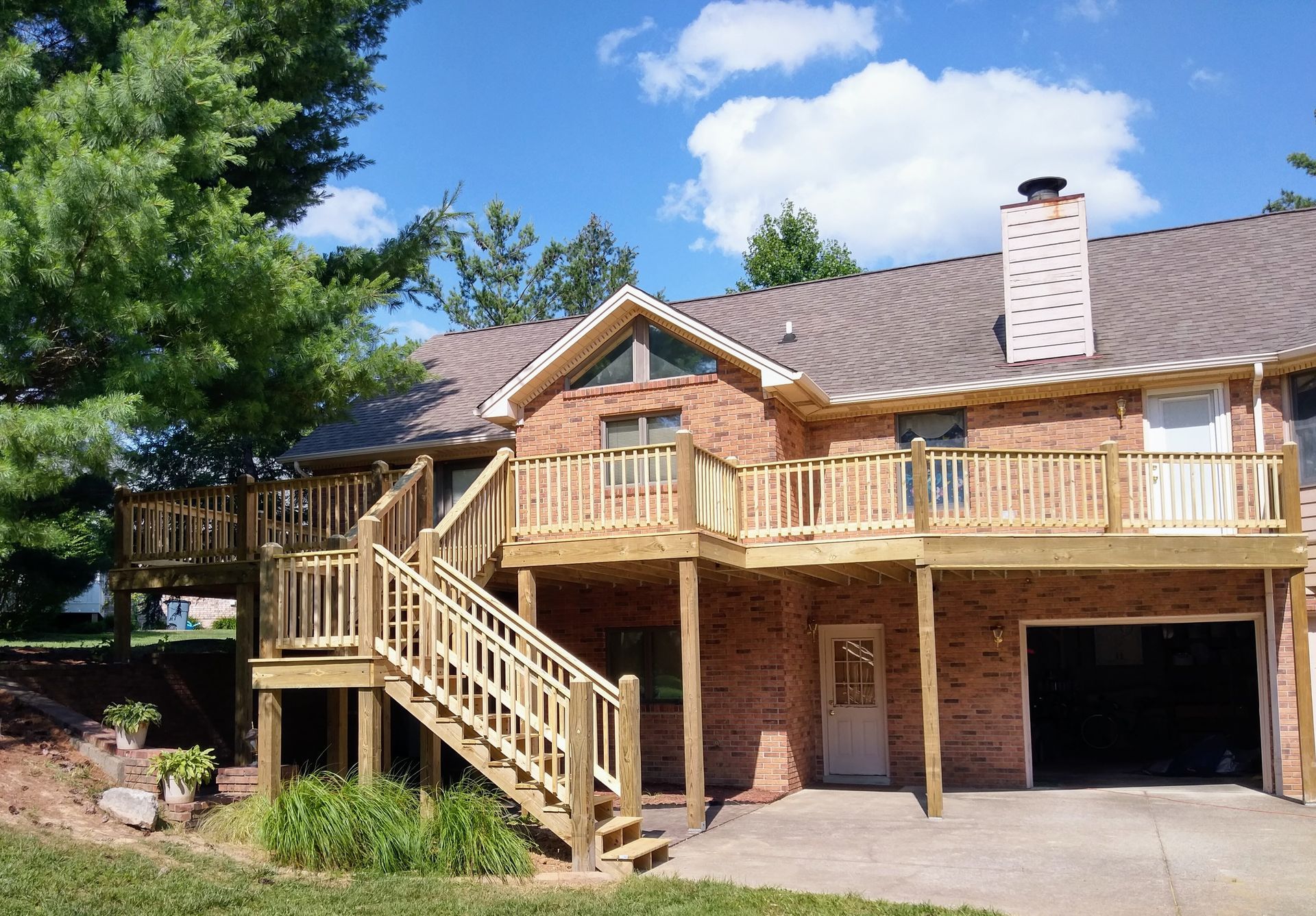 A brick house with a wooden deck and stairs